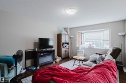Wood-finish flooring, bay window, built-in cabinetry, flush-mount ceiling light - 