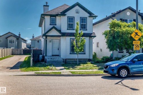 Two-story residential structure featuring white siding and dark green trim - 203 84 Street Sw, Edmonton, AB - Outdoor With Facade