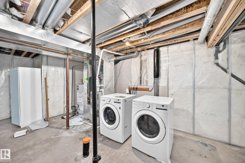 Utility space featuring concrete flooring and exposed ceiling joists - 203 84 Street Sw, Edmonton, AB - Indoor Photo Showing Laundry Room
