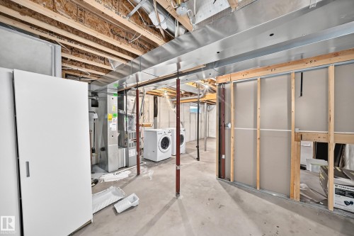 Unfinished basement space featuring exposed wood joists, ductwork, and framing for future customization - 203 84 Street Sw, Edmonton, AB - Indoor Photo Showing Basement
