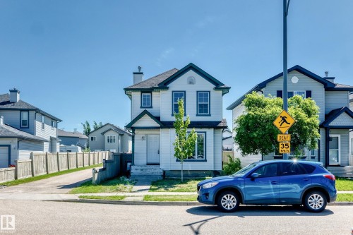 White two-story residence featuring dark trim and a gabled roofline - 203 84 Street Sw, Edmonton, AB - Outdoor With Facade
