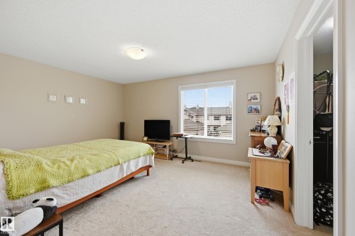 Recessed lighting, neutral wall tones, large window with blinds, light-toned carpet, and a white interior door - 1111 176 Street Sw, Edmonton, AB 