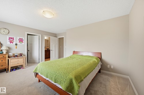 Neutral-toned walls, light-colored carpeting, and a flush-mount ceiling light - 1111 176 Street Sw, Edmonton, AB 