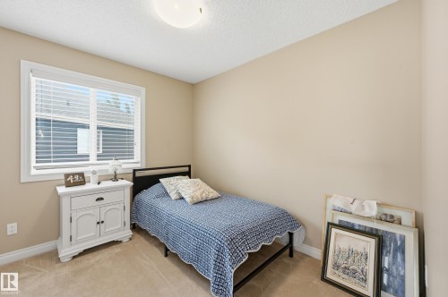 Soft neutral wall color, carpet flooring, window with blinds, and white trim - 1111 176 Street Sw, Edmonton, AB 