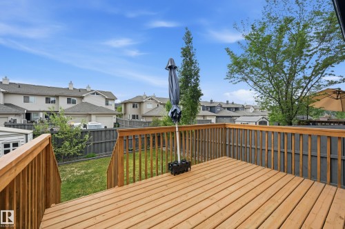 Wood-plank deck with railing, stairs, and integrated storage shed - 1111 176 Street Sw, Edmonton, AB 