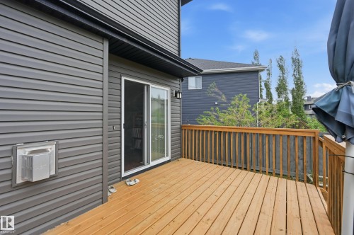 Expansive wood deck with a natural finish, featuring wood railings and a direct access sliding glass door - 1111 176 Street Sw, Edmonton, AB 