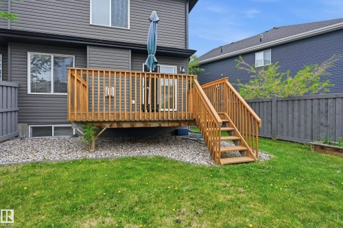 Wood deck with railing and stairs, gravel ground cover, and a grassy yard - 1111 176 Street Sw, Edmonton, AB 
