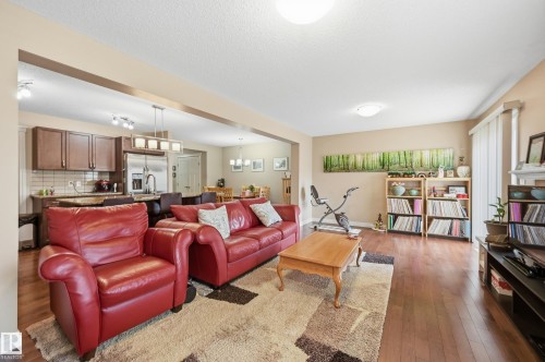 Hardwood-finish flooring throughout, complemented by a tray ceiling with flush mount lighting - 1111 176 Street Sw, Edmonton, AB 