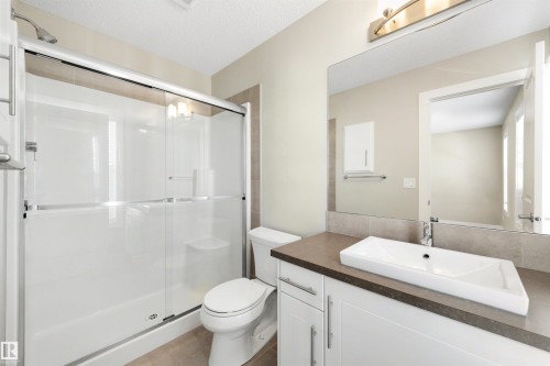 Full vanity with a rectangular vessel sink, extended counter space, and built-in cabinetry - 2125 24 Street Nw, Edmonton, AB 