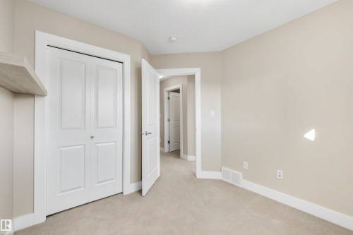 Neutral-toned walls complement plush carpeting - 2125 24 Street Nw, Edmonton, AB 