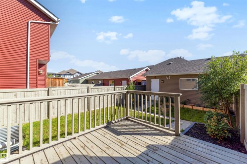 Wood-finish deck with railing, providing outdoor living space - 2125 24 Street Nw, Edmonton, AB 