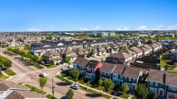 Residential neighborhood featuring a mix of detached and attached homes with varied exterior finishes - 
