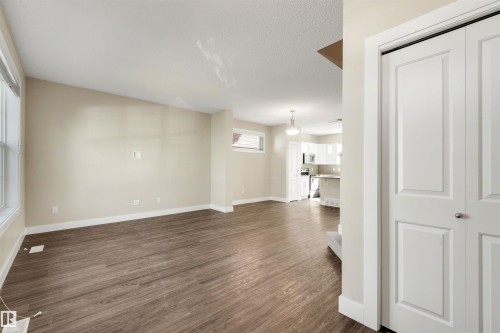 Wood-finish flooring throughout the main living area, complemented by neutral wall tones - 2125 24 Street Nw, Edmonton, AB 