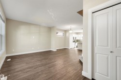 Wood-finish flooring throughout the main living area, complemented by neutral wall tones - 