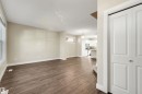 Wood-finish flooring throughout the main living area, complemented by neutral wall tones - 2125 24 Street Nw, Edmonton, AB 