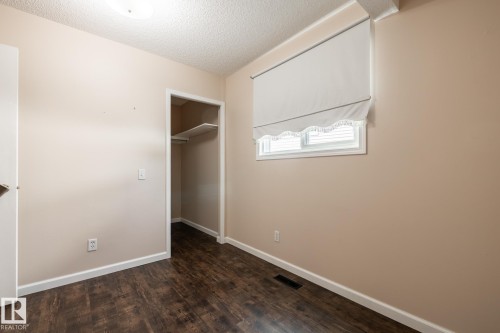 Wood-finish flooring, neutral wall paint, and white trim - 89 Ozerna Road Nw, Edmonton, AB 