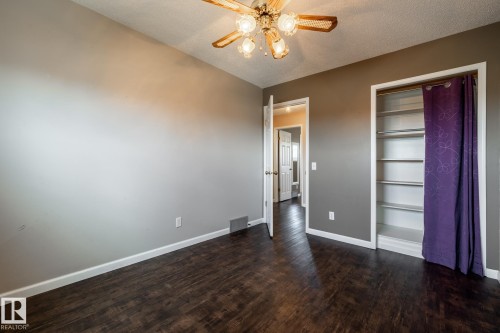 Wood-finish flooring, overhead ceiling fan with light, and built-in closet shelving - 89 Ozerna Road Nw, Edmonton, AB 