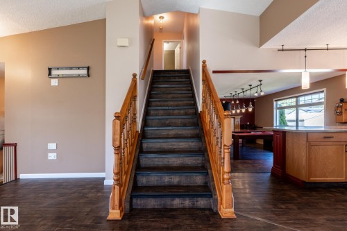Staircase featuring wood treads and a turned wood balustrade - 89 Ozerna Road Nw, Edmonton, AB 