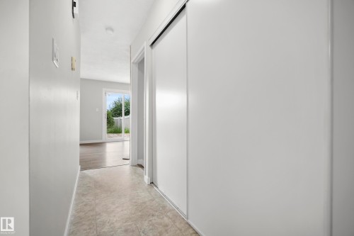 Entryway featuring light-toned flooring and white sliding closet doors - 3173 139 Avenue Nw, Edmonton, AB 
