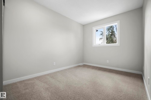 Neutral wall color, wall-to-wall carpeting, white trim, and a window with white frame - 3173 139 Avenue Nw, Edmonton, AB 