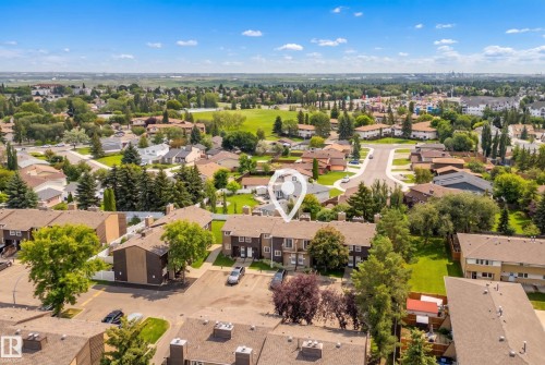 Aerial perspective showcasing a residential community with mature trees and green spaces - 3173 139 Avenue Nw, Edmonton, AB 