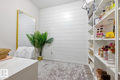 Built-in shelving, white shiplap wall accent, and recessed lighting - #155 1818 Rutherford Rd Sw, Edmonton, AB 