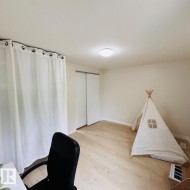 Room featuring light wood-finish flooring and a neutral color palette - 
