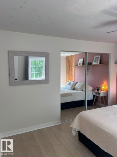 Light wood-finish flooring with white baseboards throughout - 8 The Parkway Northwest, Edmonton, AB - Indoor Photo Showing Bedroom