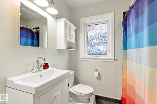 White vanity with an integrated sink and chrome faucet - 10943 72 Avenue Nw, Edmonton, AB 
