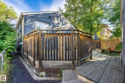 Multi-level wood deck with a privacy fence, leading to a paver pathway - 