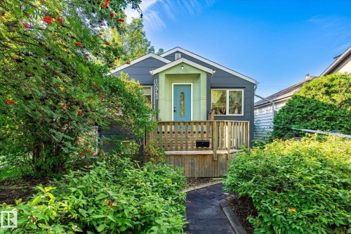 Front facade with a covered entry, wood-toned porch, and complementary siding - 10943 72 Avenue Nw, Edmonton, AB 