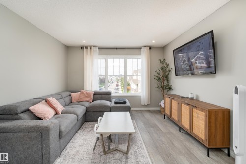 Expansive window with white grilles, recessed ceiling lighting, and wood-finish flooring - 20247 16 Avenue Nw, Edmonton, AB 