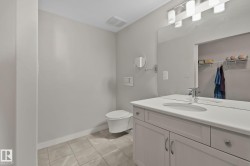 Floating vanity with an integrated sink, polished chrome faucet, and expansive mirror - 