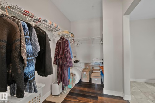 Walk-in closet featuring wood-finish flooring, wire shelving, and white walls - #404 2755 109 St Nw, Edmonton, AB 