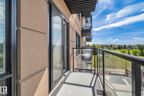 Private balcony featuring a glass and metal railing, concrete flooring, and sliding glass doors - #404 2755 109 St Nw, Edmonton, AB 