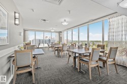 Expansive room with floor-to-ceiling windows, recessed lighting, and patterned carpeting - 