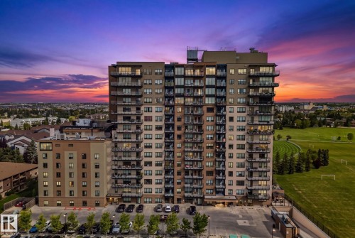 Multi-story building featuring numerous balconies, extensive window placements, and an adjacent parking area - #404 2755 109 St Nw, Edmonton, AB 