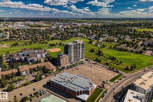 Expansive residential development with a prominent high-rise structure, multiple multi-story buildings, and substantial surface parking areas - #404 2755 109 St Nw, Edmonton, AB 