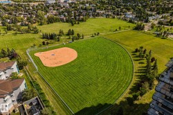 Expansive green spaces featuring a baseball diamond and additional recreational fields - 