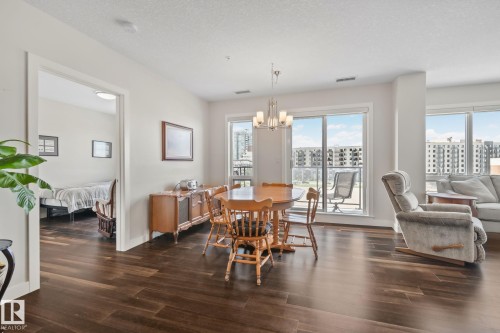 Spacious interior with dark wood-finish flooring - #404 2755 109 St Nw, Edmonton, AB 