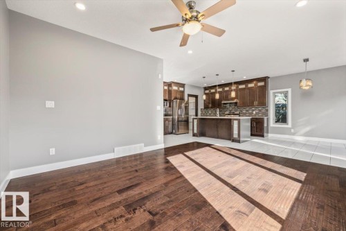 Open-concept living space featuring wood-finish flooring, recessed lighting, and a ceiling fan - 1090 Armitage Crescent Sw, Edmonton, AB 