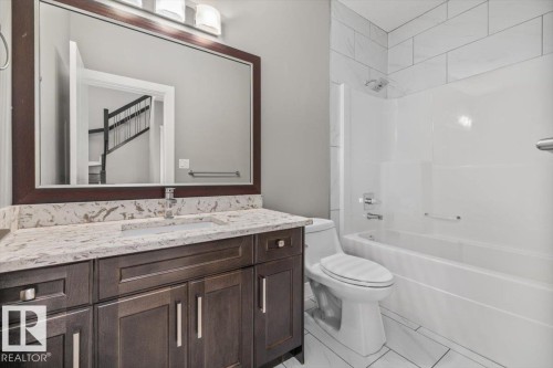 Dark wood-finish vanity with a light-toned countertop - 1090 Armitage Crescent Sw, Edmonton, AB 