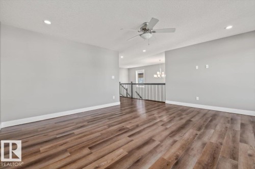 Wood-finish flooring with white trim - 1090 Armitage Crescent Sw, Edmonton, AB 