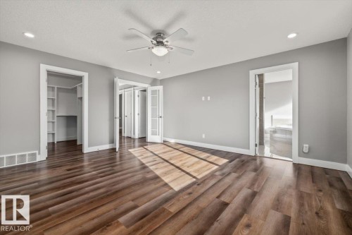 Recessed lighting, ceiling fan, wood-finish flooring, built-in closet shelving, and French doors - 1090 Armitage Crescent Sw, Edmonton, AB 