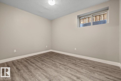 Neutral-toned walls complement wood-finish flooring - 1090 Armitage Crescent Sw, Edmonton, AB 