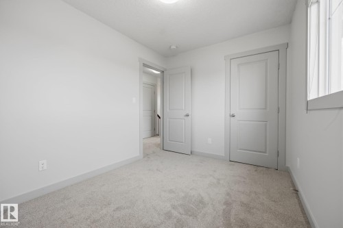Soft neutral carpeting and light gray wall paint - 8952 81 Avenue Nw, Edmonton, AB 