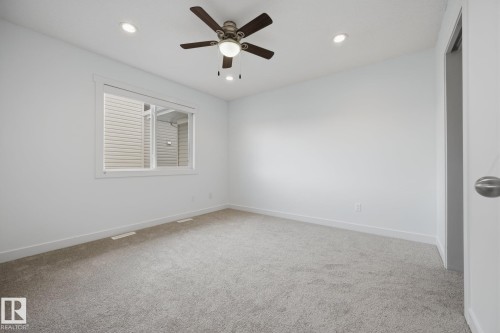 Recessed lighting, ceiling fan with integrated light, light gray carpeting, and white walls - 8952 81 Avenue Nw, Edmonton, AB 