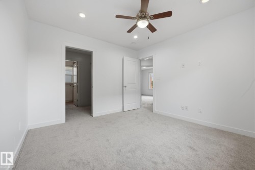 Recessed lighting, ceiling fan, neutral carpet, and white interior doors - 8952 81 Avenue Nw, Edmonton, AB 