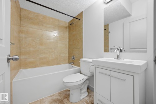 White vanity with integrated rectangular sink and chrome faucet - 8952 81 Avenue Nw, Edmonton, AB 