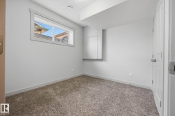 Carpeted flooring, neutral wall color, window with trim, white interior door, recessed ceiling light - 